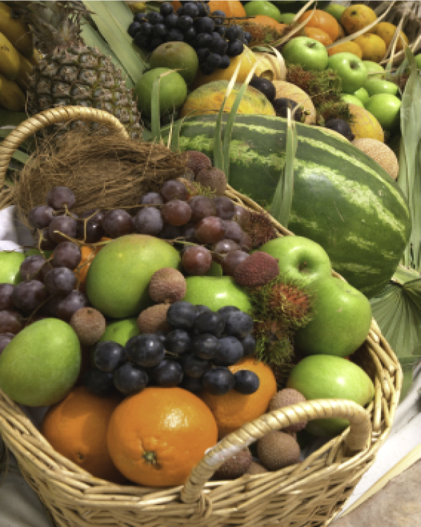 A wicker basket full of colorful fruit.