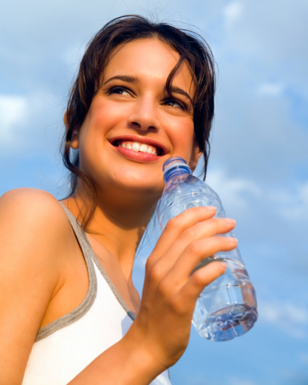 A woman holding onto a water bottle in her hand